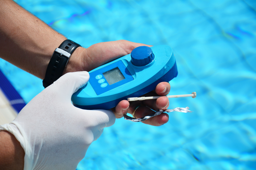 Pool technician testing water