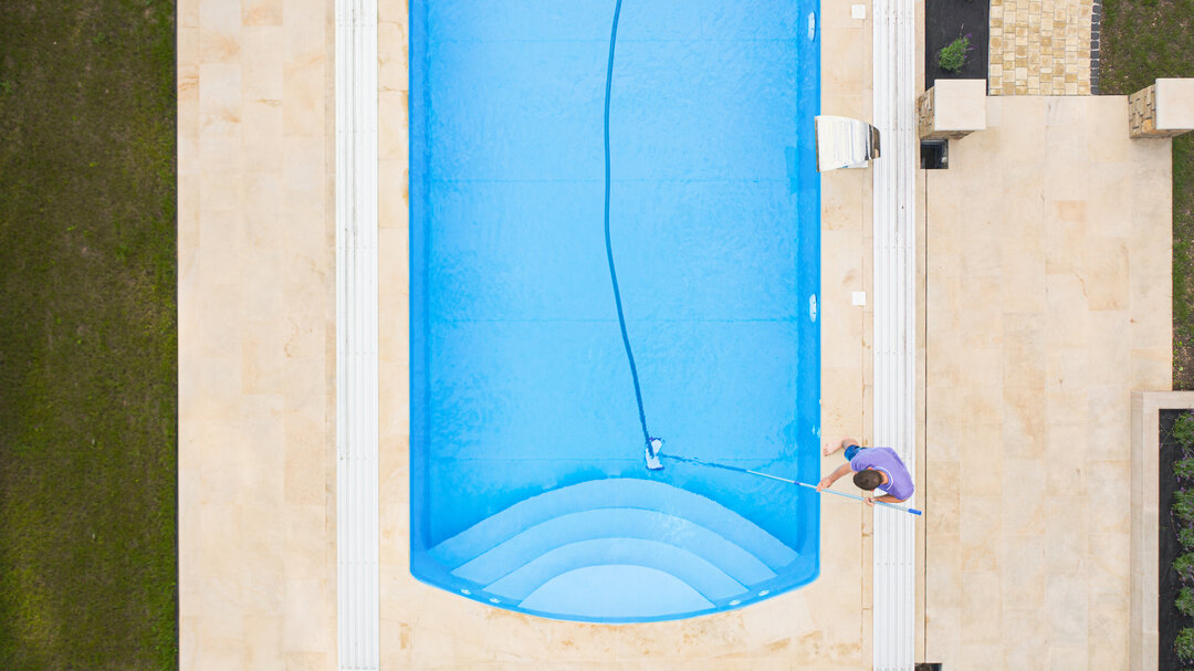 Man cleaning a pool